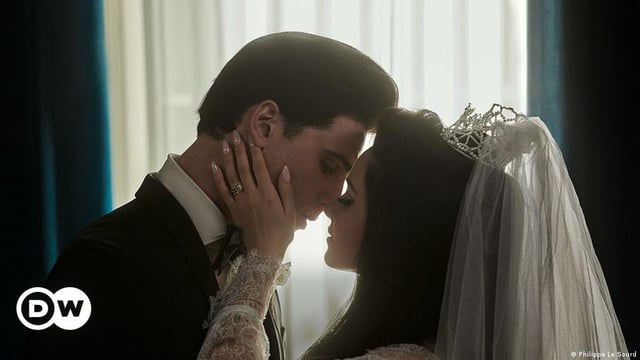 Film still 'Priscilla': actors who look like Elvis and Priscilla Presley about to kiss on wedding day.