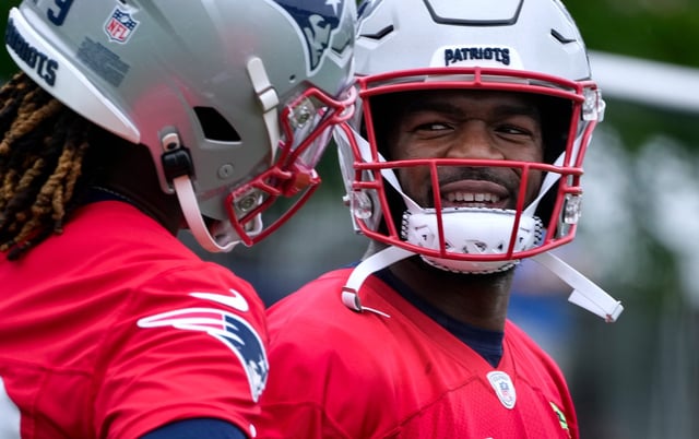 Patriots quarterback Jacoby Brissett joking with teammate Joe Milton III during first day of training camp Wednesday morning.