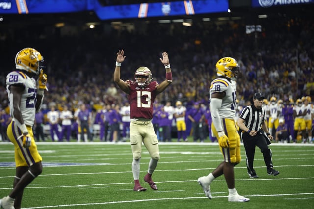 Quarterback Jordan Travis #13 of the Florida State Seminoles reacts after a touchdown against the LSU Tigers at Caesars Superdome on September 04, 2022 in New Orleans, Louisiana.