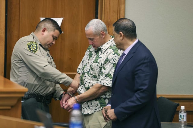 FILE - A court officer removes Albert "Ian" Schweitzer's handcuffs following the judge's decision to release him from prison immediately, after spending more than 20 years in prison, Jan. 24, 2023, in Hilo, Hawaii. A man who was identified as a new suspect in the murder and sexual assault of a woman visiting Hawaii more than three decades ago committed suicide after police took a DNA swab from him, but before he could be arrested, attorneys said in court filings late Sunday, July 28, 2024.. The DNA work represented a major development in a case that was in the headlines last year when Schweitzer, ,a man who'd been incarcerated for more than 20 years for the murder, was released based on fresh evidence. (Marco Garcia/The Innocence Project via AP Images, File)