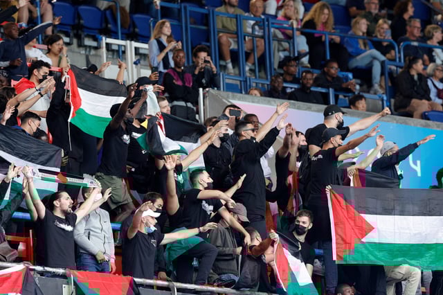 Fans wave Palestine flags while making antisemitic gestures during the men's soccer match between Israel and Paraguay at the Olympic Games in Paris on July 27, 2024.