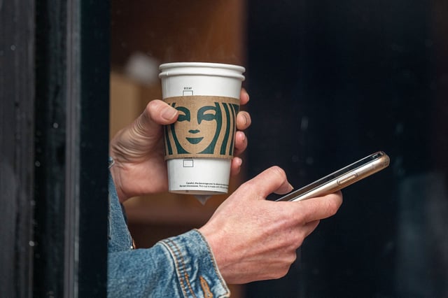 A customer holds a drink inside a Starbucks coffee shop in San Francisco, California, US, on Thursday, July 28, 2022.