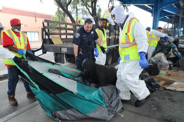 San Francisco Public Workers and the San Francisco Police Department are seen removing a homeless person’s tent with their belongings on Tuesday July 20, 2024.