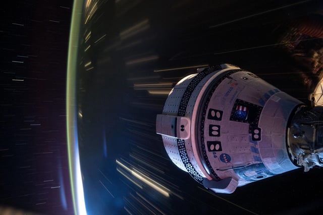 Boeing's Starliner spacecraft that launched NASA's Crew Flight Test astronauts Butch Wilmore and Suni Williams to the International Space Station is pictured docked to the Harmony module's forward port. This long-duration photograph was taken at night from the orbital complex as it soared 258 miles above western China. Credit: NASA