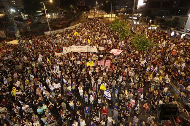 Supporters and relatives of Israelis held hostage by Palestinian militants in the Gaza Strip since October lift placards during a rally to demand their release in Tel Aviv on August 3, 2024.