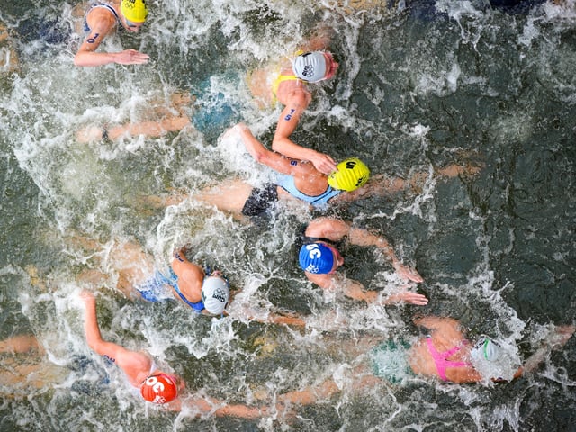 FILE - Australia's Natalie Van Coevorden (15), Belgium's Claire Michel (5) and Ekaterina Shabalina, of Kazakhstan (32) compete in the swim leg of the women's individual triathlon competition at the 2024 Summer Olympics, Wednesday, July 31, 2024, in Paris, France. Belgium's Olympic committee announced Sunday Aug.4, 2024 that it would withdraw its team from the mixed relay triathlon at the Paris Olympics after one of its competitors who swam in the Seine River fell ill. Claire Michel, who competed in the women's triathlon Wednesday, "is unfortunately ill and will have to withdraw from the competition," the Belgian Olympic and Interfederal Committee said in a statement. (AP Photo/David Goldman, File)