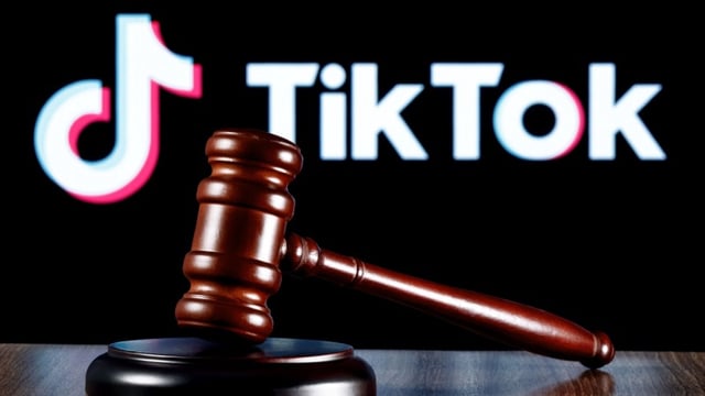 Gavel on table against background of TikTok indicating lawsuit