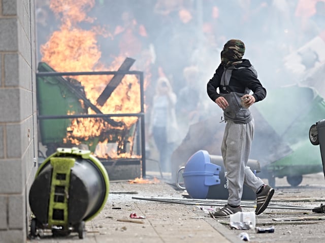 ROTHERHAM, ENGLAND - AUGUST 4: Anti-migration protesters are seen during riots outside of the Holiday Inn Express in Manvers, which is being used as an asylum hotel, on August 4, 2024 in Rotherham, United Kingdom. Yesterday saw widespread violence as Far-right agitators in Liverpool and Manchester rioted and looted shops. Police were attacked and injured and dozens of arrests were made. (Photo by Christopher Furlong/Getty Images)