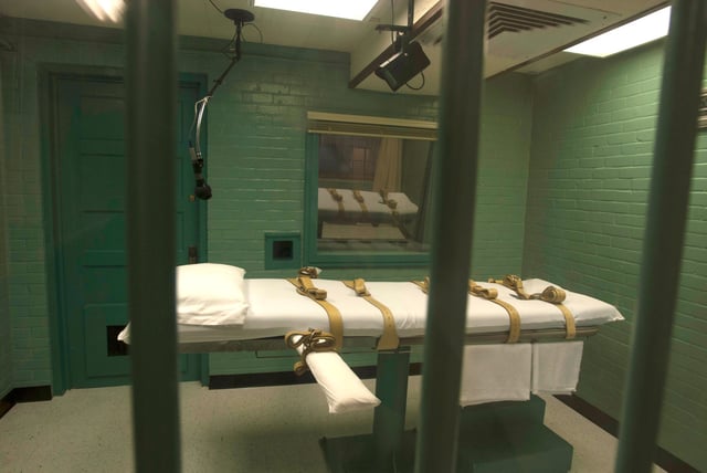 The death chamber is seen through the steel bars from the viewing room at the state penitentiary in Huntsville, Texas in this September 29, 2010 handout.