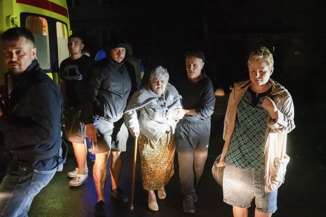 Residents leave an apartment building damaged by Ukrainian shelling in Kursk on Sunday.