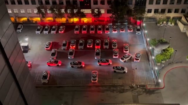 An image about Self-driving cars are gathering at night to honk at each other
