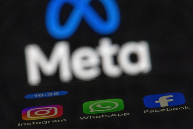 ILLUSTRATION - 16 May 2024, Mecklenburg-Western Pomerania, Schwerin: ILLUSTRATION - The apps Instagram, Facebook and WhatsApp can be seen on the display of a smartphone in front of the logo of the Meta internet company. The internet programs belong to Meta, the umbrella brand of the Facebook Group. The European Commission is opening proceedings against the Facebook and Instagram parent company Meta on suspicion of violations of the protection of minors. Photo: Jens Büttner/dpa (Photo by Jens Büttner/picture alliance via Getty Images)