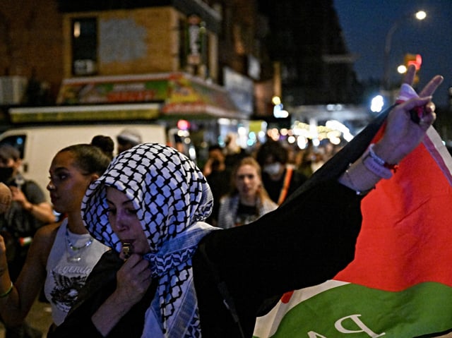 NEW YORK, UNITED STATES - AUGUST 14: People, holding banners and Palestinian flags, gather to protest a campaign event for Democratic presidential candidate U.S. Vice President Kamala Harris in New York, United States on August 14, 2024. (Photo by Fatih Aktas/Anadolu via Getty Images)