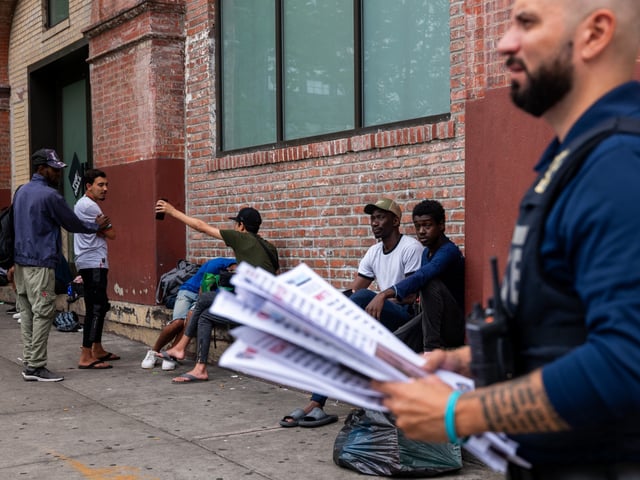 NEW YORK, NEW YORK - JULY 24: Police put up 'wanted' posters outside of two shelters in Brooklyn housing recently arrived migrant men on July 24, 2024 in New York City. Over the weekend two men were killed and a third man was hospitalized in critical condition after gunfire erupted at two separate scenes in Brooklyn near the shelters that police now believe may be related to gang violence in Venezuela. Recent neighborhood protests against the shelters have begun as residents demand that migrants be moved to other neighborhoods. (Photo by Spencer Platt/Getty Images)
