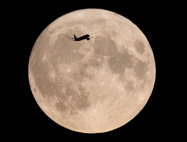 Mandatory Credit: Photo by Peter MacDiarmid/Shutterstock (14074378m)
An aircraft passes in front as a rare Blue Full Moon, which is also a Supermoon, rises over central London. A blue Moon occurs when there are two full moons in any one calendar month. Both of August's full moons were also Supermoons - this will not be repeated for the next 14 years.
Rare Blue Moon rises over London, London, UK - 30 Aug 2023