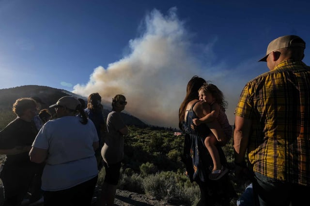 Residents watch as the Sheep fire burns in Wrightwood, California, in June 2022.