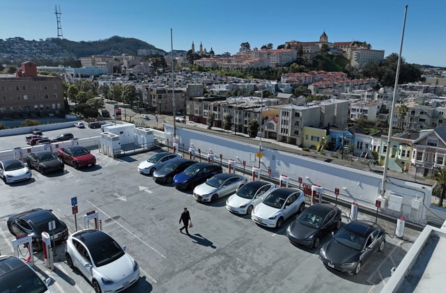 In an aerial view, Tesla cars recharge at a Tesla Supercharger station on February 15, 2023 in San Francisco, California.