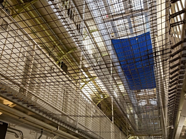 Upward view of the Wing Levels in Her Majesty’s Prison Pentonville, London, United Kingdom. 
Pentonville is a local prison and holds Category B and C males and A Wing is for this who are on remand and convicted. The prison was built in 1816 as a modern prison and was uniquely designed for rehabilitation.  It was the first radial design prison which allowed staff to view all 5 wings from the central hall. The prison remains largely untouched from its original design, however netting has been added across the levels to prevent suicide.  (photo by Andrew Aitchison / In pictures via Getty Images)