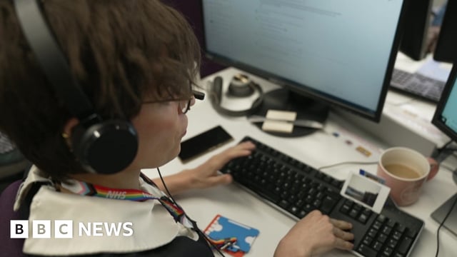 One of the trained counsellors, Chris, wearing a headset at her computer