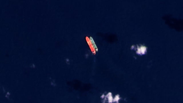 FILE - In this satellite photo provided by Planet Labs PBC, vessels identified as the Virgo, left, and the Suez Rajan, by the advocacy group United Against Nuclear Iran, are seen in the South China Sea on Feb. 13, 2022. A Greek shipper has pleaded guilty to a charge over it smuggling sanctioned Iranian crude oil and agreed to pay a $2.4 million fine, U.S. federal court papers seen Thursday, Sept. 7, 2023 by The Associated Press show. (Planet Labs PBC via AP, File)