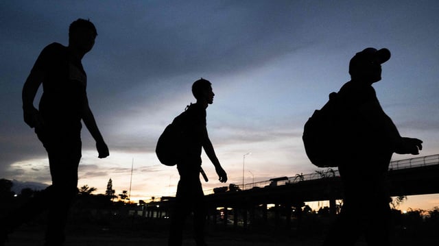 Venezuelans walk to a US Border Patrol processing center after they crossed the Rio Grande river and over the razor wire to cross into Eagle Pass, Texas on September 25, 2023.