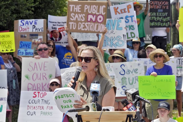 Democratic Florida State Rep. Lindsay Cross speaks to supporters against development at Florida state parks outside the entrance to Honeymoon Island State Park on Tuesday in Dunedin, Florida. (Chris O'Meara / AP)