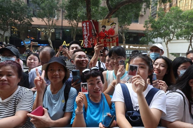 Fans wait patiently outside the hotel for a glimpse of the stars. Photo: Edmond So