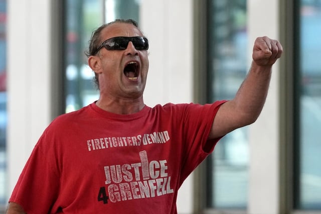 A protester outside the Grenfell Tower Inquiry in London today, wearing a "Justice 4 Grenfell' shirt  