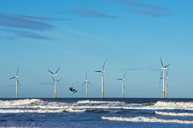 Offshore windfarm and kite surfer in Yorkshire, UK. Credit: John Morrison / Alamy Stock Photo.