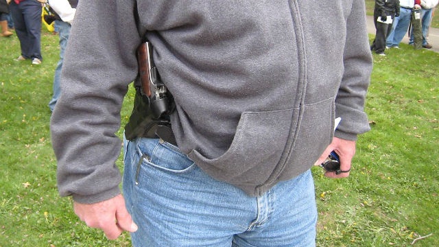 A handgun in a holster that can be concealed by clothing. Photo via Wikimedia Commons