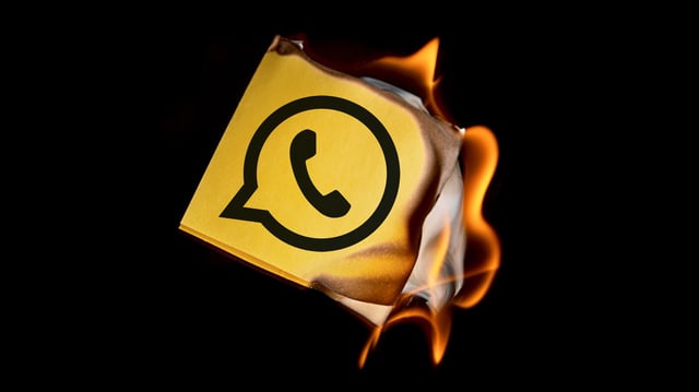 The WhatsApp logo on a burning piece of paper. (Image: simonkr / Getty Images / modified by TechCrunch)