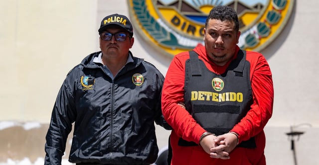 Peruvian police escort a member of the Tren de Aragua crime gang in Lima, Peru, on Oct. 5, 2023. The Venezuelan gang that sows terror in several South American countries has now come to America. (Cris Bouroncle/AFP/Getty Images)