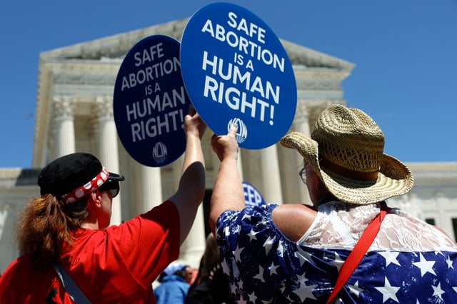 Abortion rights activists hold signs as they gather at the U.S. Supreme Court to mark the second anniversary of the Court overturning Roe v. Wade, in Washington, U.S., June 24, 2024. , U.S., June 24, 2024. REUTERS/Evelyn Hockstein/File Photo