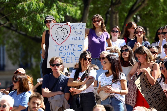 People gather next to a placard that reads: "Gisele for all women, all women for Gisele", during a demonstration in support of Gisele Pelicot, who was allegedly drugged and raped by men solicited by her husband Dominique Pelicot, and of all rape victims, as the trial continues, near the courthouse in Marseille, France, September 14, 2024. REUTERS/Manon Cruz