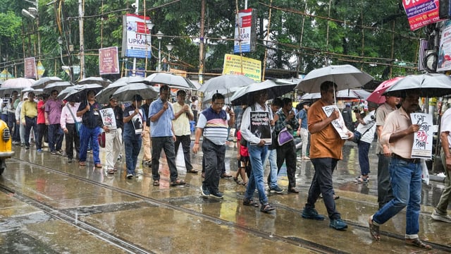 Kolkata: Joint forum of engineers, scientists and technologists participate in a rally during rain in protest against the alleged rape and murder of a medic at RG Kar Medical College and Hospital, in Kolkata, Saturday, Sept. 14. (PTI Photo/Swapan Mahapatra)