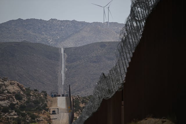 US Customs and Border Protection Border Patrol vehicles sit parked along fencing between the United States and Mexico on August 1, 2024, in Jacumba Hot Springs, California.