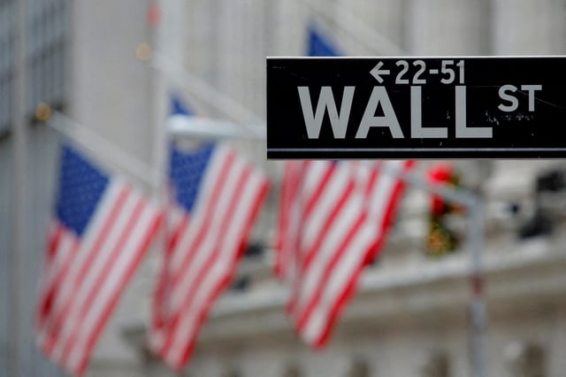 A street sign for Wall Street is seen outside the New York Stock Exchange (NYSE) in Manhattan, New York City, U.S. December 28, 2016. REUTERS/Andrew Kelly//File Photo