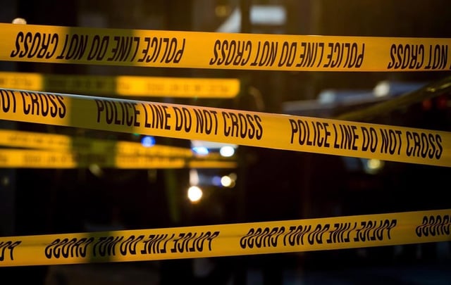 Police tape cordons off a crime scene in Vancouver, B.C., on April 9, 2015. The Integrated Homicide Investigation Team says the 26-year-old son of a man found dead on British Columbia's Sunshine Coast has been charged with his murder. THE CANADIAN PRESS/Darryl Dyck