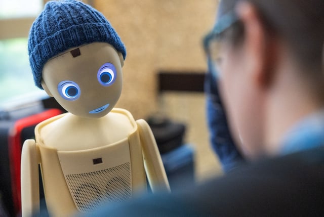 A visitor talks with the Navel robot, by Navel Robotics, during the AI for Good Global summit on artificial intelligence, organised by the International Telecommunication Union (ITU), in Geneva, Switzerland, May 30, 2024. REUTERS/Denis Balibouse/File photo