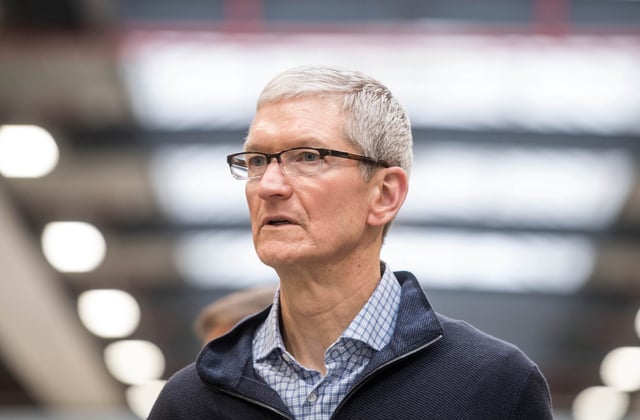 Apple CEO Tim Cook looks on during a visit of the shopfitting company Dula that delivers tables for Apple stores worldwide in Vreden, western Germany, on February 7, 2017. (Photo: BERND THISSEN/AFP/Getty Images)