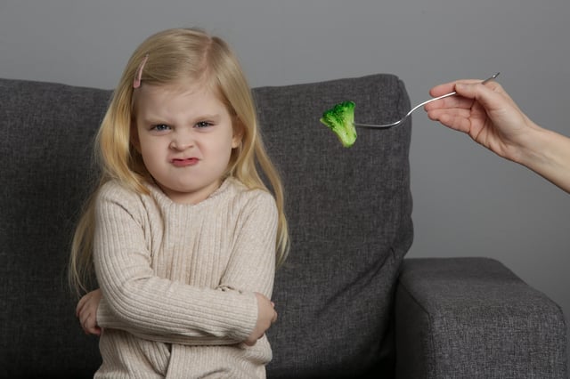 Little girl does not want broccoli