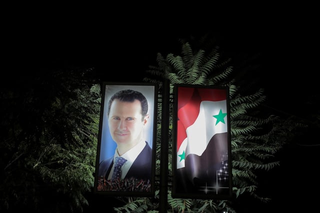A picture of Syrian President Bashar al-Assad is seen at a train station in Damascus, Syria, September 12, 2018. Picture taken September 12, 2018. REUTERS/Marko Djurica/File Photo