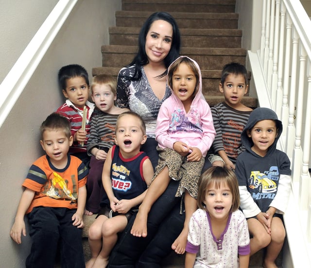In this Oct. 23, 2012, file photo, Nadya Suleman, rear center, poses with some of her children at their new home in Palmdale, Calif. From left, back row, are Makai, Noah, Suleman, Nariyah, on her lap and Isaiah; from left front, Jonah, Josiah, Maliyah and Jeremiah.