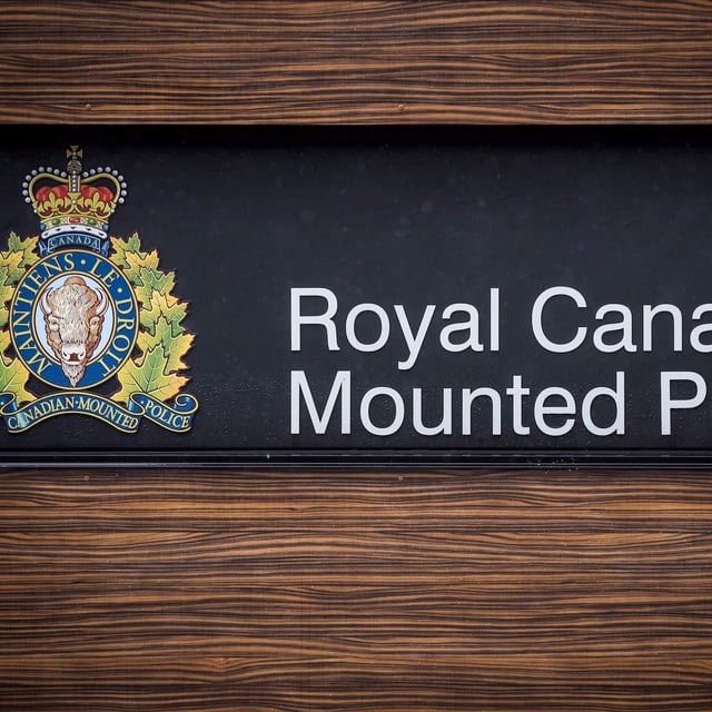 The RCMP logo is seen outside Royal Canadian Mounted Police "E" Division Headquarters, in Surrey, B.C., on Friday April 13, 2018. Saskatchewan's police watchdog is investigating the shooting death of a man facing several arrest warrants for robbery. THE CANADIAN PRESS/Darryl Dyck